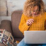 Woman does her keyword research on a laptop