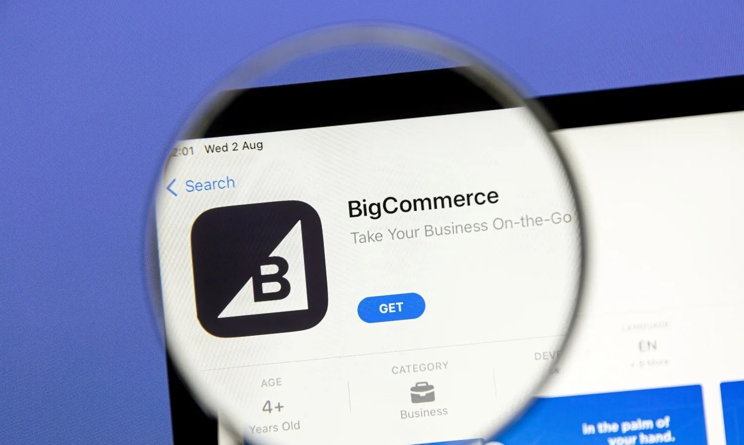 BigCommerce ecommerce app listing displayed on a mobile marketplace screen under magnifying glass