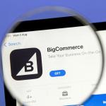 BigCommerce ecommerce app listing displayed on a mobile marketplace screen under magnifying glass