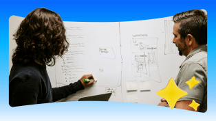 Two salesforce employees plot out a wireframe on a whiteboard.