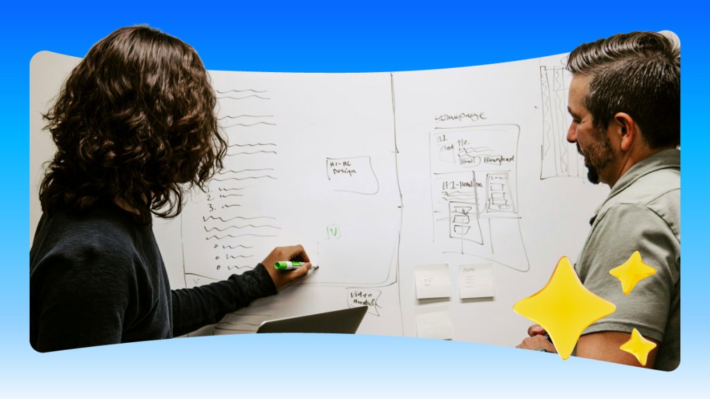 Two salesforce employees plot out a wireframe on a whiteboard.