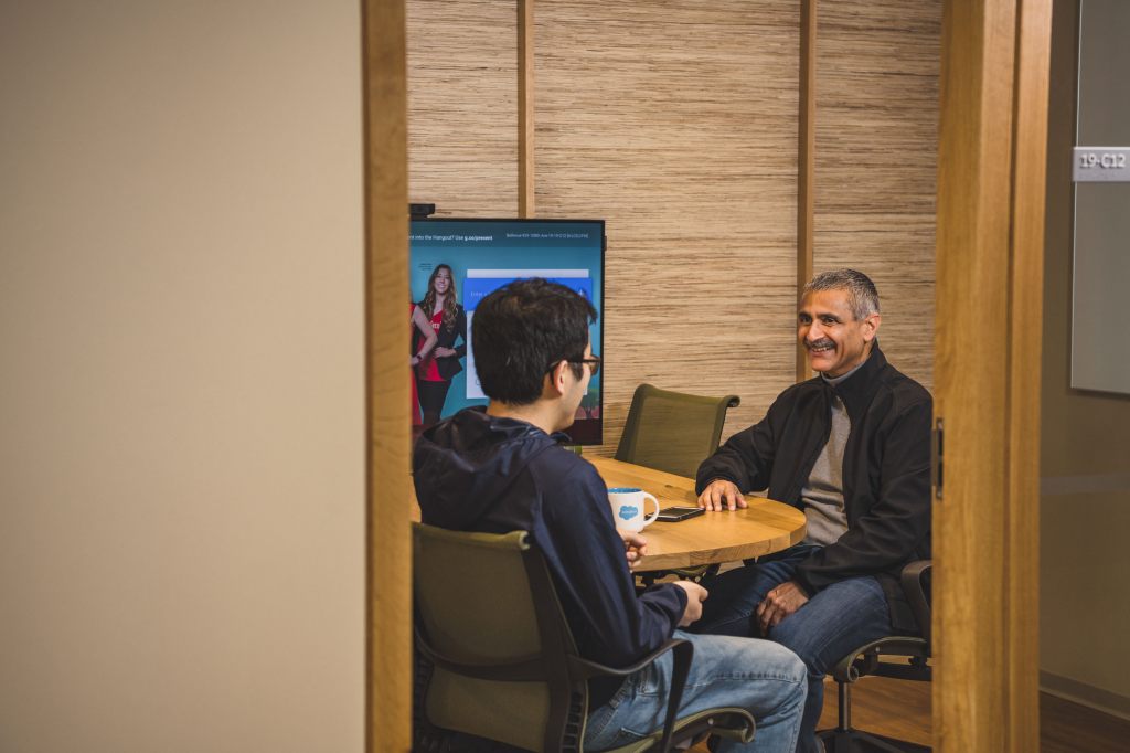 Salesforce employees meet at a conference room in the Bellevue office.