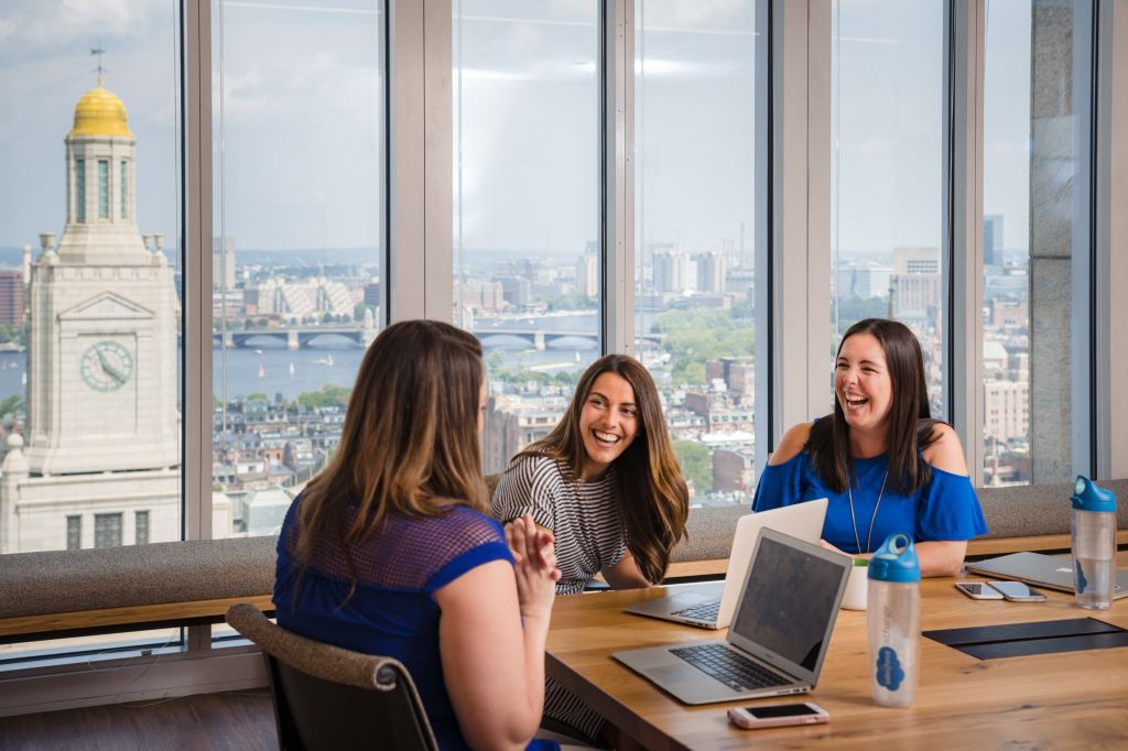 Employees at Salesforce Boston take some time to catch up during their meeting.