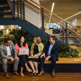 Salesforce New York employees chat by the stairs