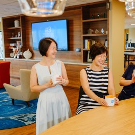 Employees in the Singapore office catch up in the common area.