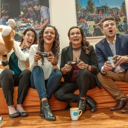 Employees at Salesforce Sydney enjoy friendly competition with a video game break.