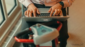 person on a scooter typing on a computer