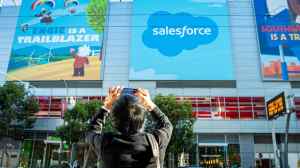 Person taking a photo of Salesforce logo billboard at Dreamforce