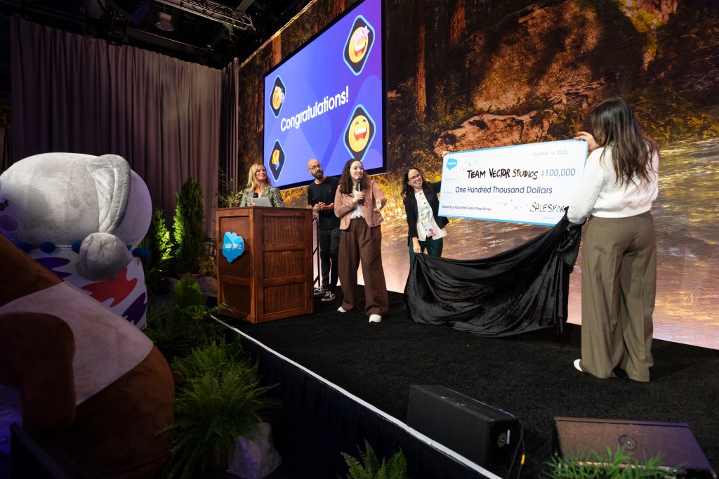 Team Vector Studios accepts the grand prize check for Dreamforce Hackathon.