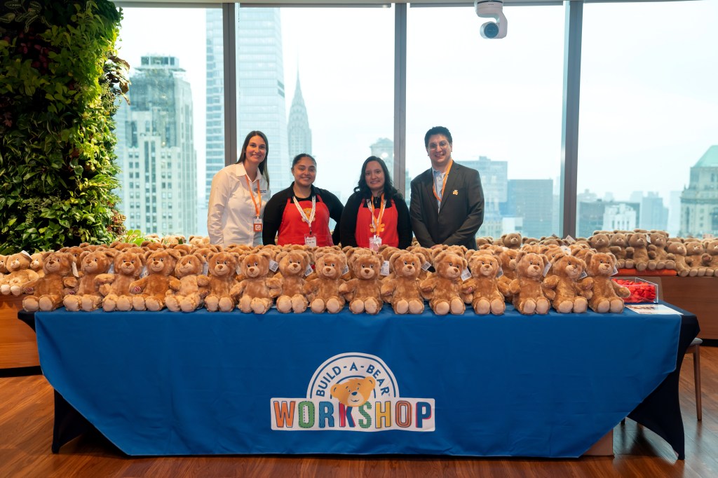 Employees, partners, and schoolchildren celebrate Giving Tuesday in New York City.