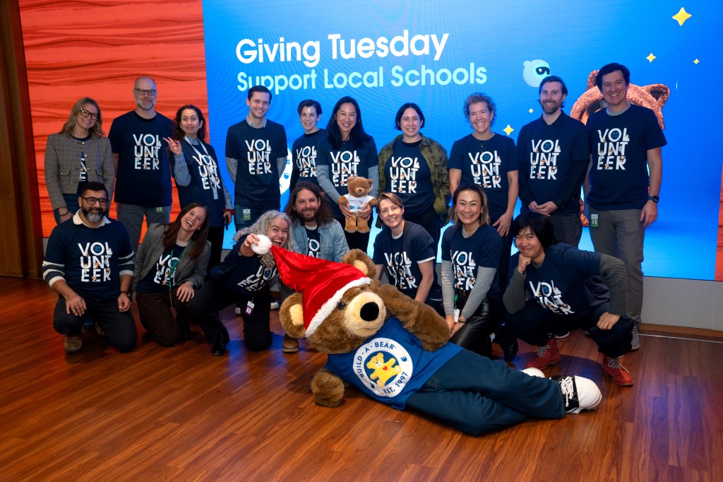 Employees, partners, and schoolchildren celebrate Giving Tuesday in New York City.