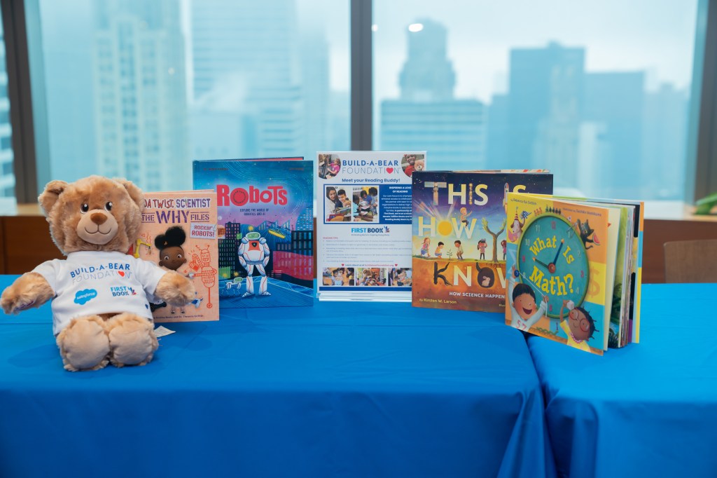 Employees, partners, and schoolchildren celebrate Giving Tuesday in New York City.
