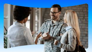 Smiling man in army fatigues discussing care options with woman.