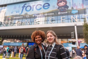 Dreamforce 2026 attendees smile for a picture in front of Moscone Center.