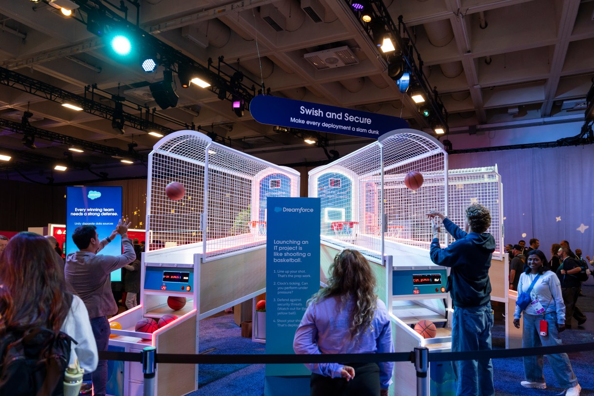 Attendees shoot hoops in a basketball themed display.