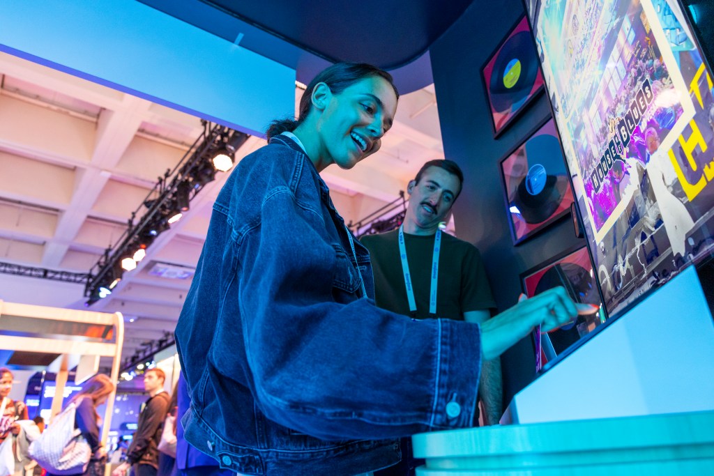 Attendees interact with a music display at Dreamforce.
