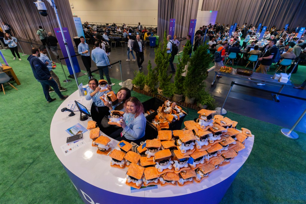 Dreamforce staff pose with smores-themed Astro plushies.