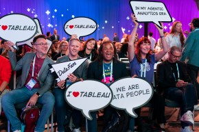 Attendees hold up signs reading "I heart Tableau" and "We are data people".