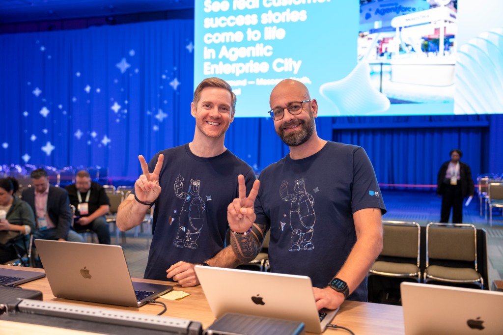 Salesforce employees prepare a demo before a session.