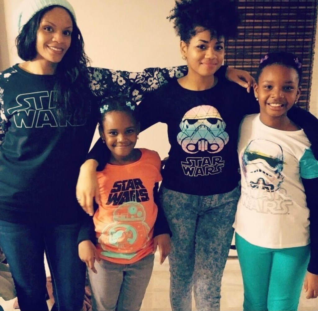 Sidibe poses with her family in Star Wars shirts